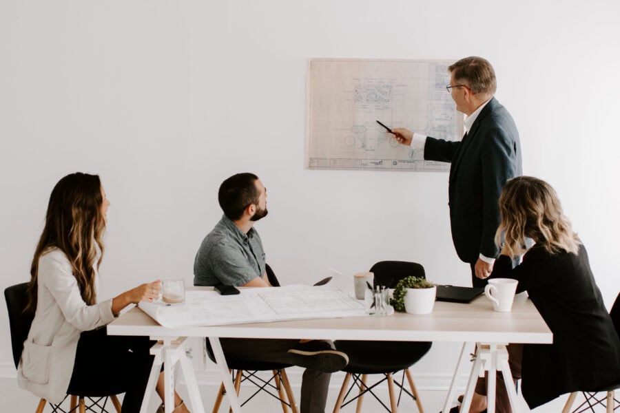 Business team discussing competition strategies in a modern office.