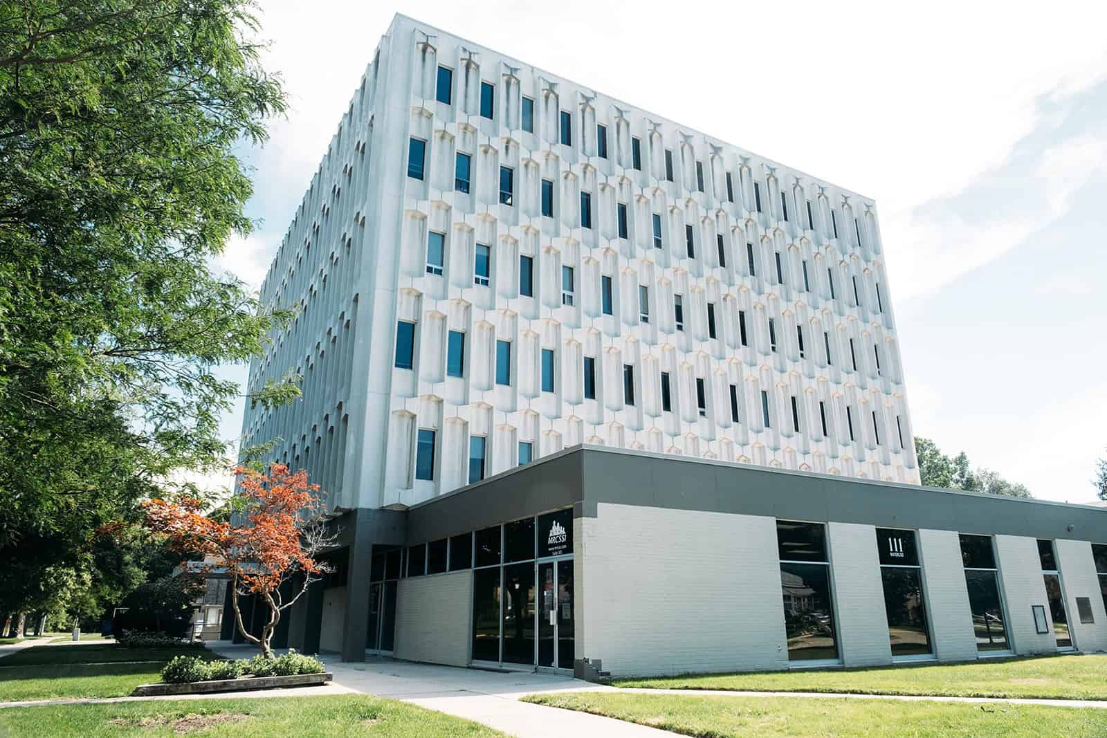 Contemporary office building with unique facade design and large windows.