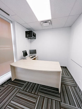 Minimalist office with desk, two monitors, and speaker system.