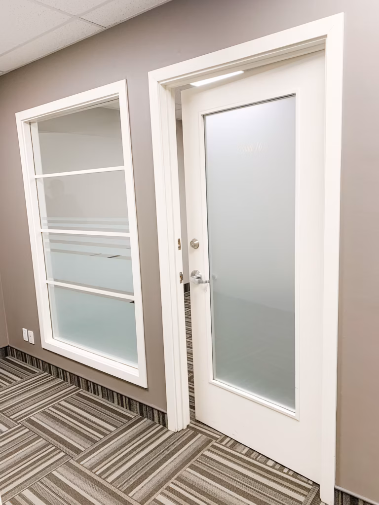Hallway with a frosted glass door labeled "Suite 16" and a large frosted window.