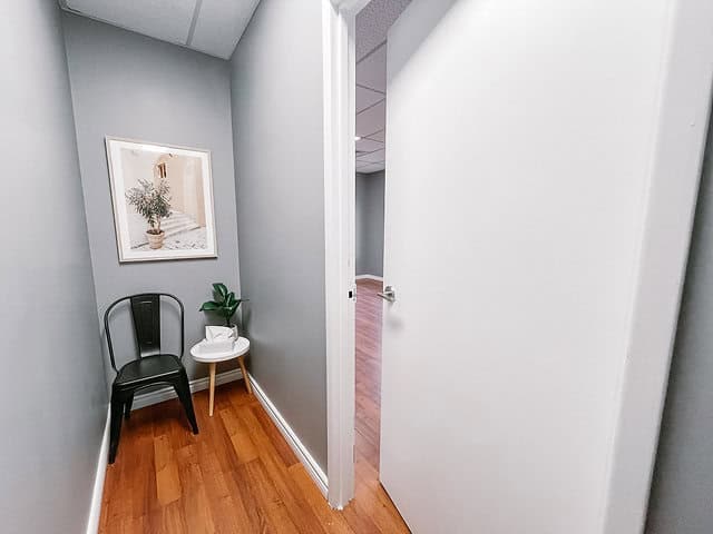 Interior view of an office entrance with chairs and artwork.