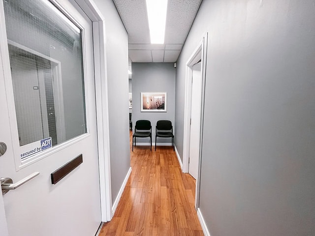 Interior view of office hallway with chairs and artwork at 120 Wellington Street.