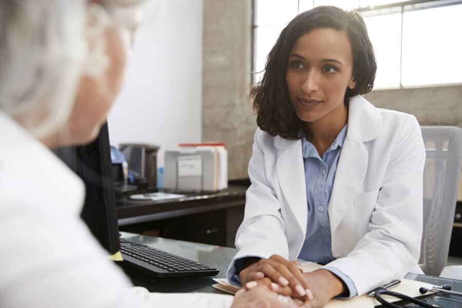 Female doctor consulting with a patient in an office setting.