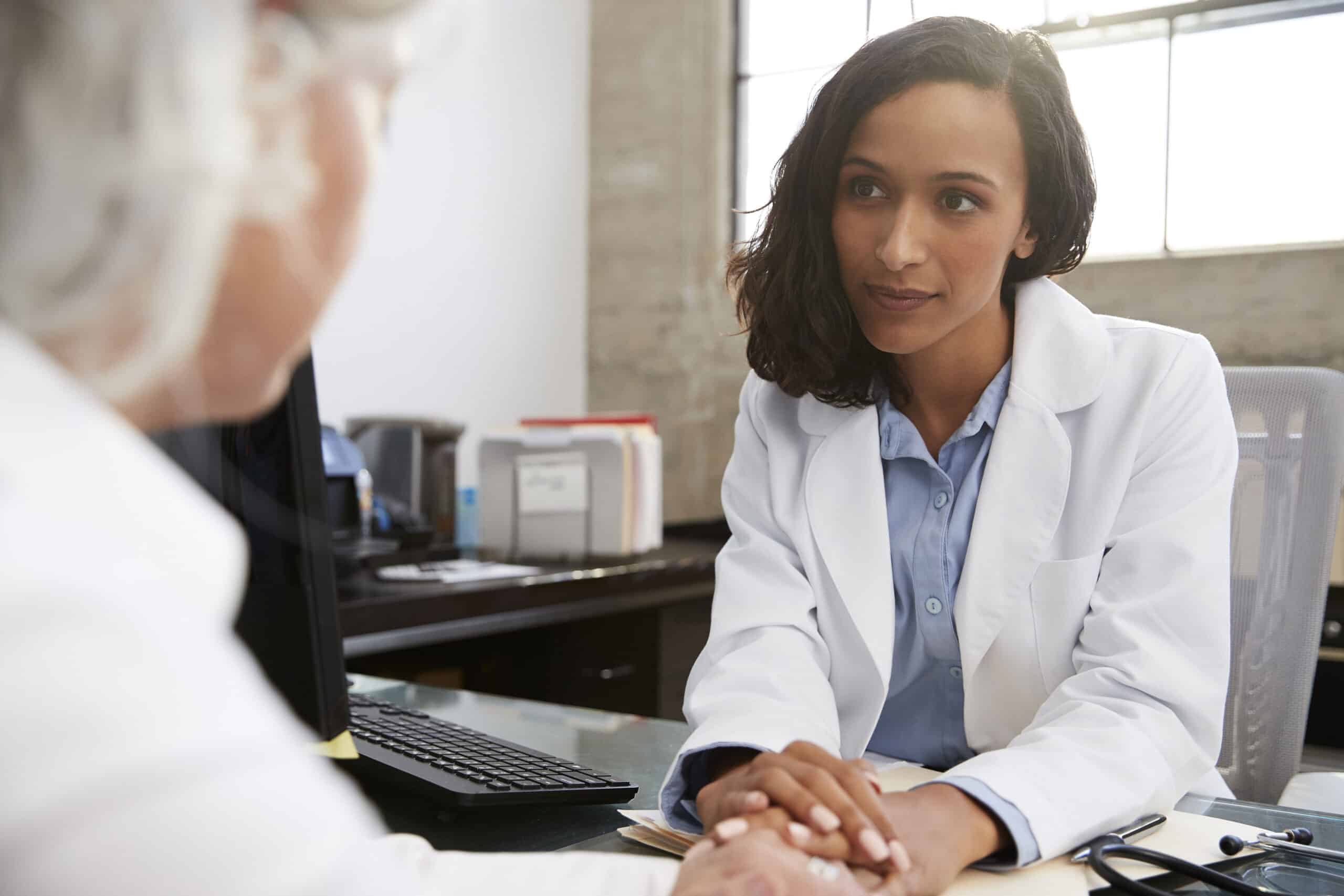 Female doctor consulting with a patient in an office setting.