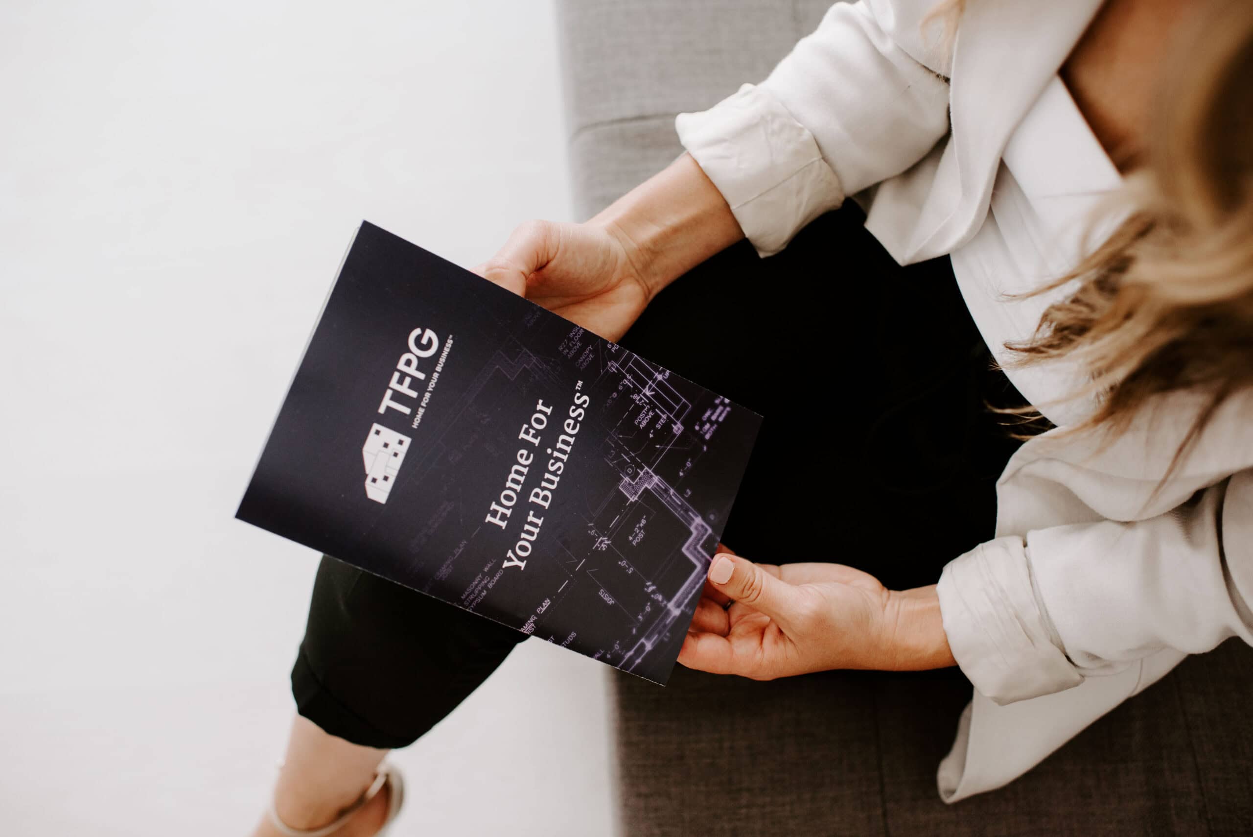 Person holding brochure for The Focal Point Group office space.