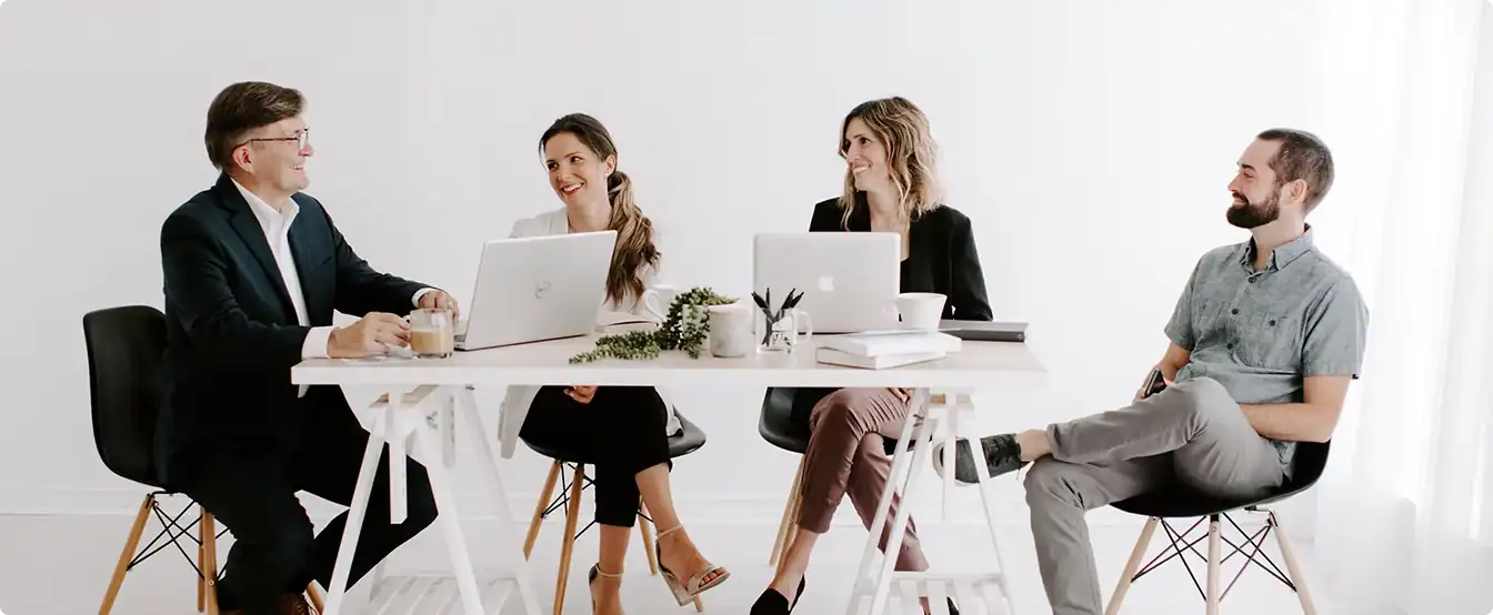 Team of four professionals in a business meeting at The Focal Point Group.