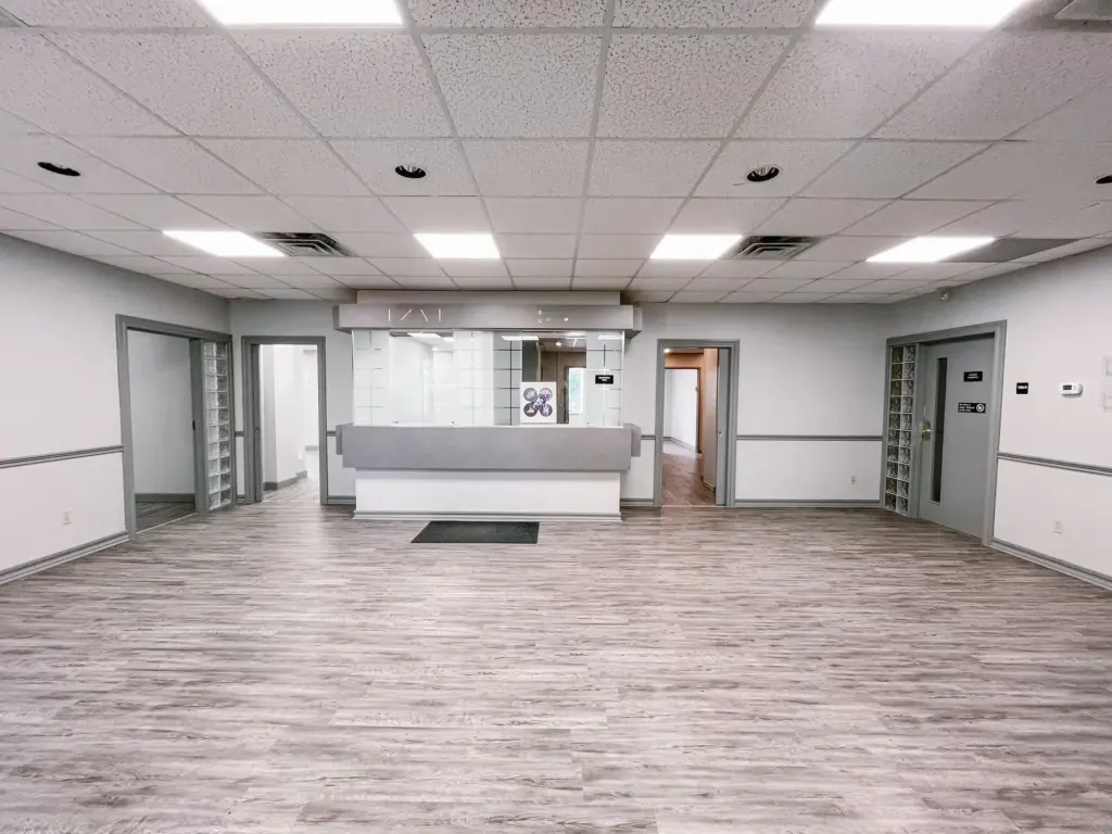 Reception desk and waiting area with wood-look flooring in Suite 106B at 353 St. Paul Avenue, Brantford.