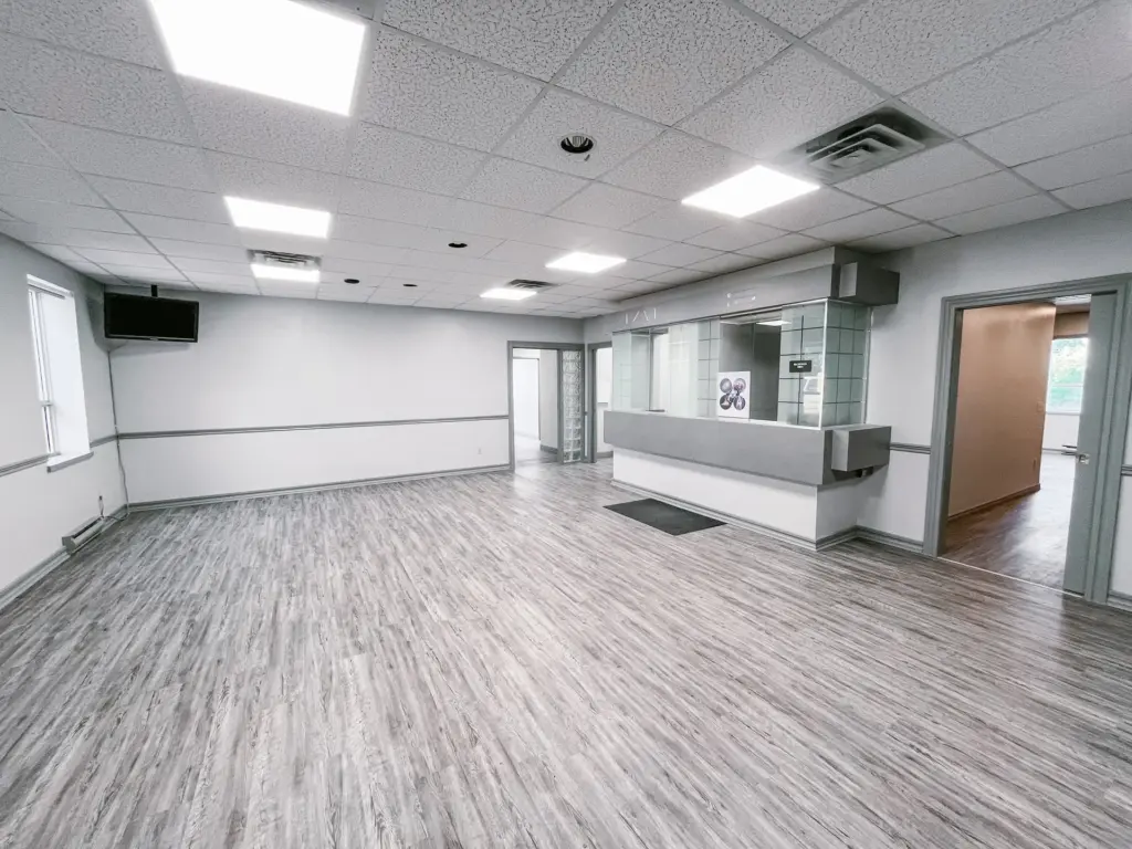 Reception counter and open waiting area with windows in Suite 106B at 353 St. Paul Avenue, Brantford.