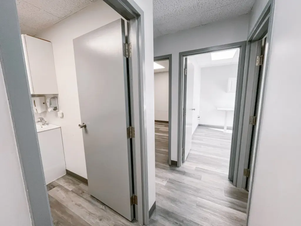 Hallway with washroom and access to the waiting area in Suite 205A at 353 St. Paul Avenue, Brantford.